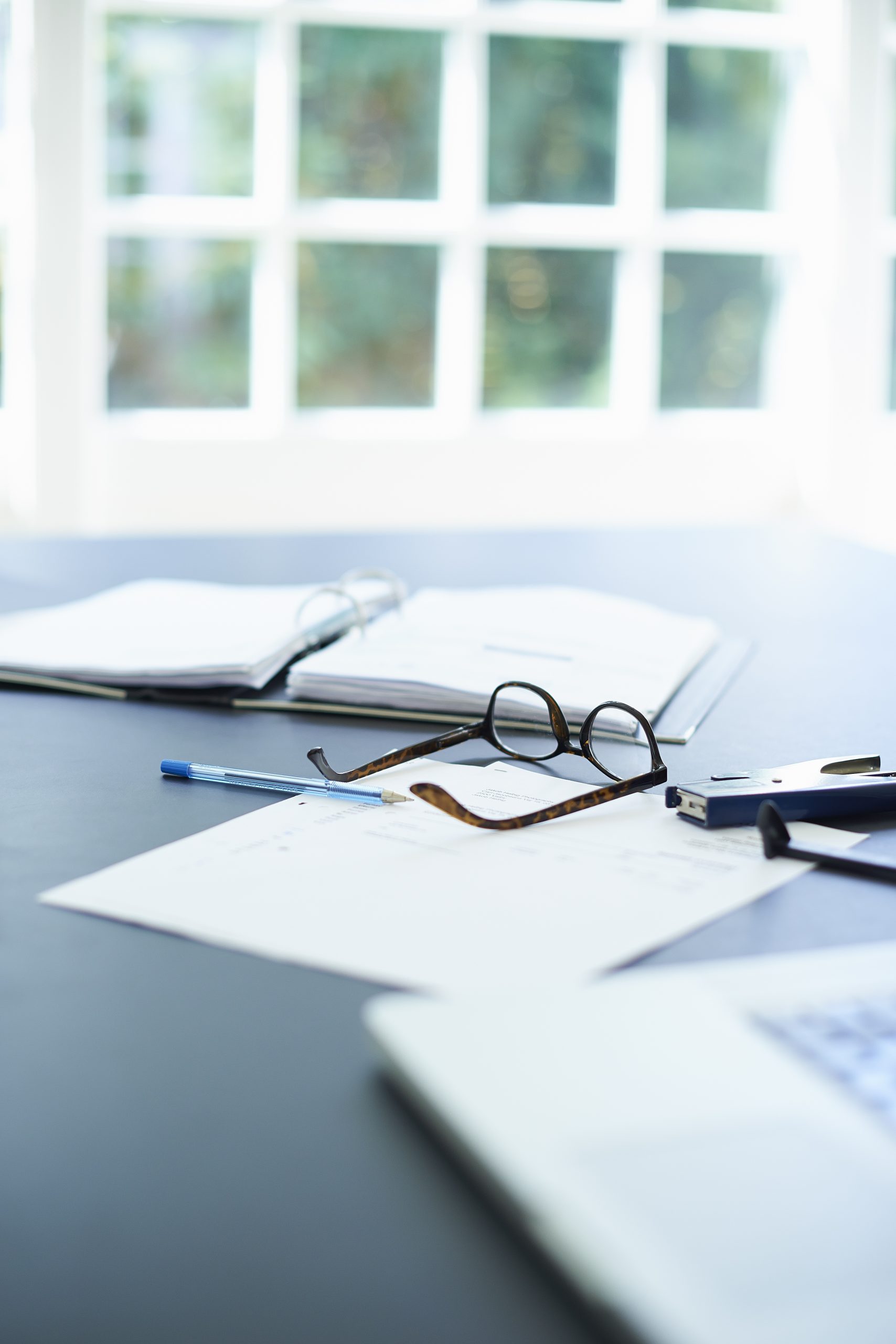 Laptop, eyeglasses and diary on dining room table